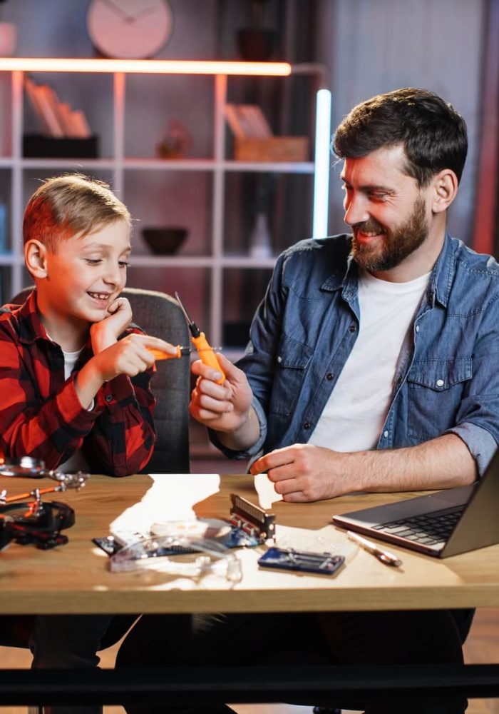 father-with-son-repairing-electronics-in-game-form.jpg